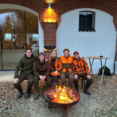 Gemeinschaft bei den Jagdtalenten: Teilnehmer am Feuer